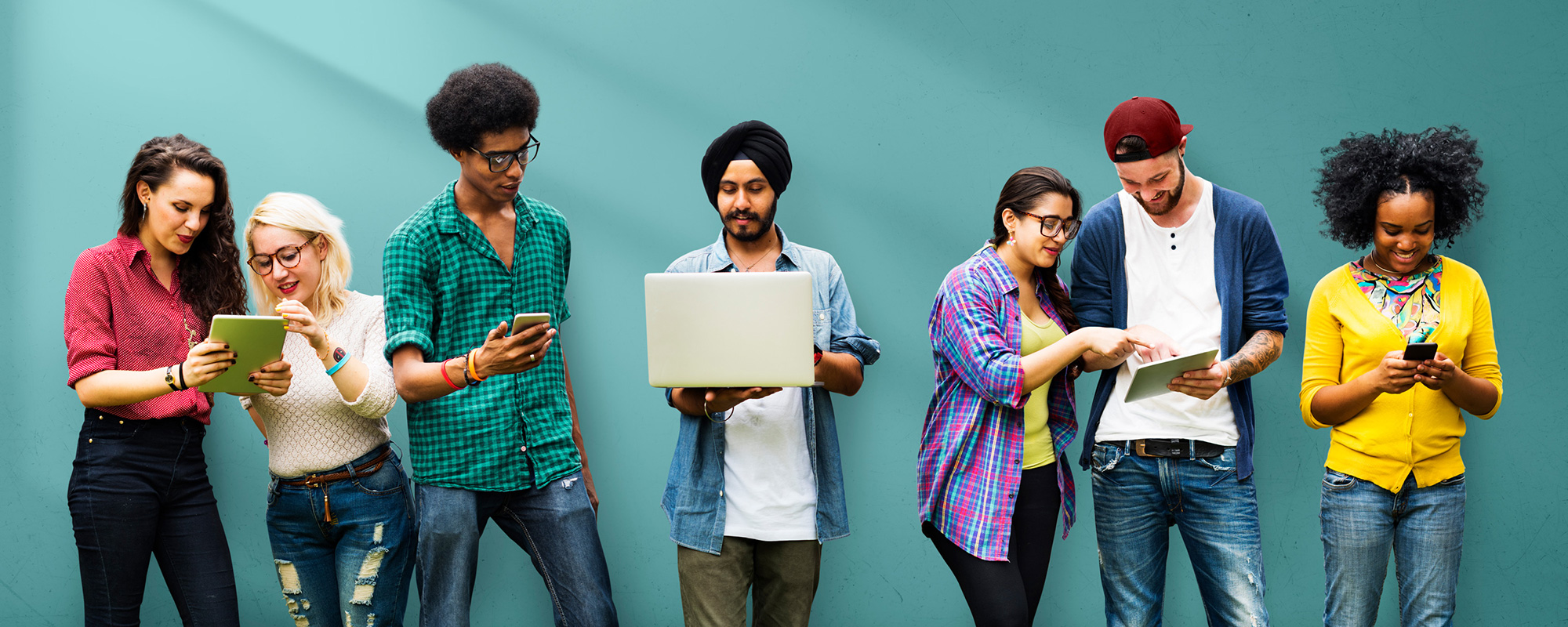Diverse group of students looking at devices
